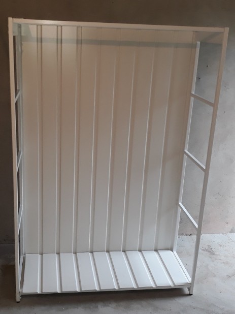 Large white wood rack with sheet metal at the bottom and at the back