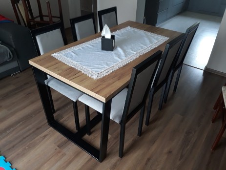 Metal table for the dining room with a wooden top together with metal chairs with upholstery
